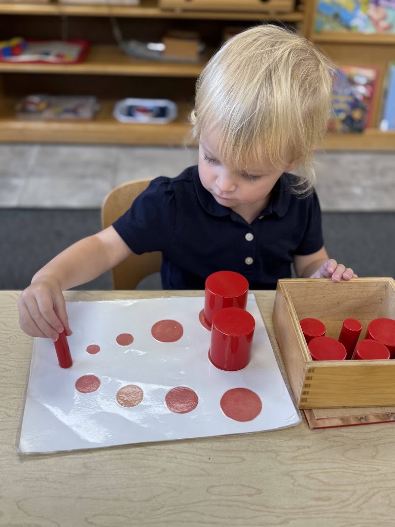 A child working independently at a table