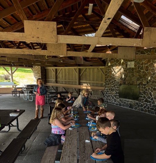 Hope Academy staff and students sharing a meal together outdoors