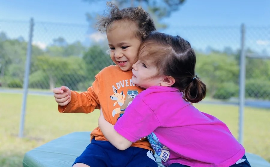 Teacher caring for children at Life House Child Enrichment Station