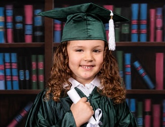 A proud young graduate in cap and gown holding her diploma